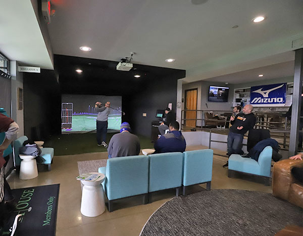 Golfers playing on the indoor simulator in Cool Springs Party Room